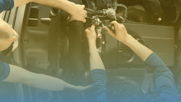 two technicians working on engine