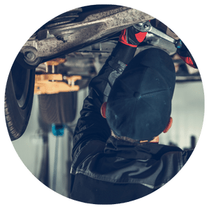 technician working under a vehicle