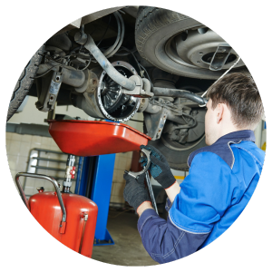 technician changing oil on car