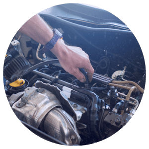 technician's hand working on engine