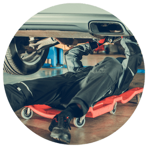 technician working under a vehicle