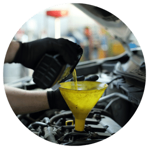 technician pouring oil into funnel 