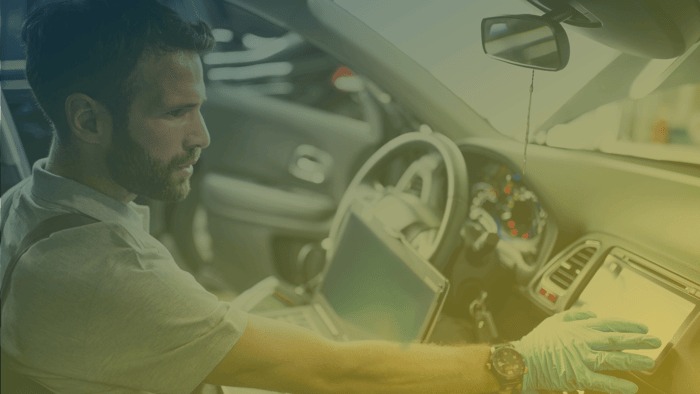 Automotive technician working on engine diagnostics.